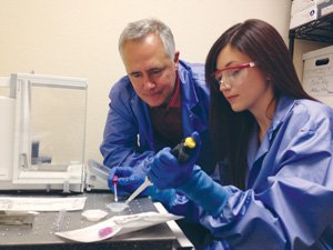 Diomics CEO Jeff Morhet and scientist Lindsey Howard use a state-of-the-art material swab called the X-Swab that was developed with a material invented at Diomics. The swab can be used to efficiently extract DNA out of materials.