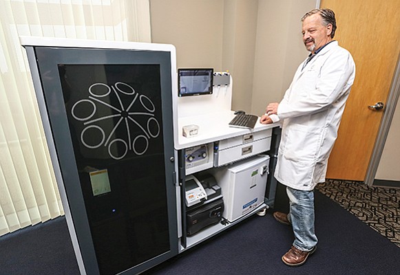 Rick Hockett, chief medical officer of Genalyte, demonstrates the company’s mobile blood testing technology. Genalyte is among the San Diego blood companies that have differentiated themselves in the wake of disgraced Theranos.