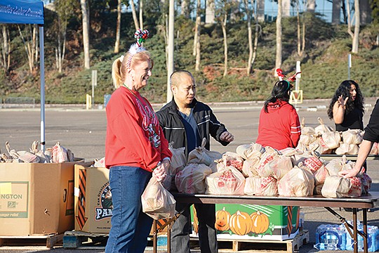 Volunteers served hundreds of people from San Diego County who came to SDCCU Stadium to receive food and toys at United Way & San Diego/Imperial Counties Labor Councils’ Annual Food & Toy Distribution. Photo courtesy of Yvonne Kwan/United Way of San Diego County