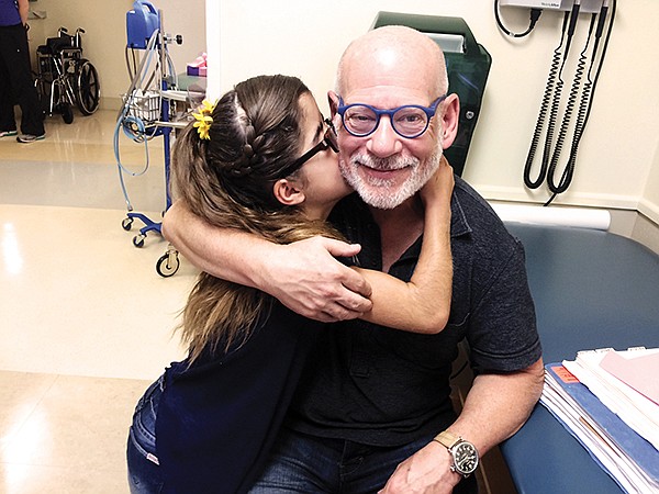Ema, a Fresh Start patient, has a kiss for Dr. Steven Cohen. Photo courtesy of Fresh Start Surgical Gifts