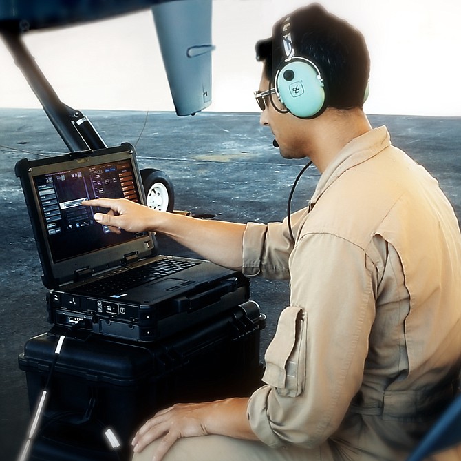 A field technician demonstrates how the XC2 portable laptop can initiate and shut down the flight of an MQ-9B remotely piloted aircraft. Photo courtesy of General Atomics Aeronautical Systems Inc.