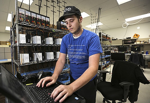 An employee configures control box electronics at SmartDrive in 2017. San Diego is home to several companies that offer telematics products and services. File photo by Jamie Scott Lytle