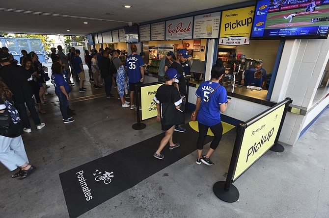 Fans line up to pick up concessions at Postmates' new locations at the LA Dodgers top deck.