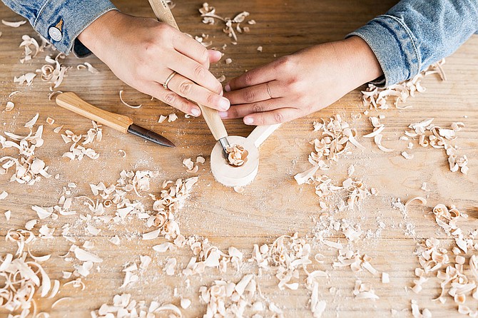 An artist carves a wooden spoon for a project with The Crafter’s Box. The San Diego-based company builds subscription boxes for crafters, and sells curated materials online. Photos courtesy of The Crafter’s Box.