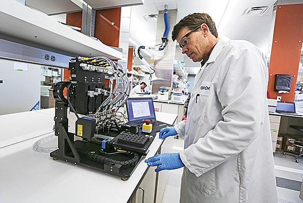 Organovo engineer Chris Shaw calibrates a 3-D bioprinter. The company’s 3-D bioprinted tissues, among other things, mimic diseases for research. Photo by Jamie Scott Lytle.