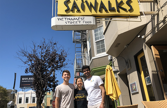 Photo courtesy of Paneau.
Co-founders Alec Fong (left) and Nader Khalil (right) stand with  a new restaurant customer at Saiwalks in San Francisco.