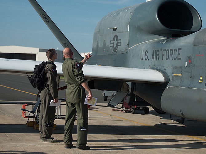 Photo courtesy of U.S. Air Force
In an image from 2018, a senior officer from the U.S. Air Force’s 7th Reconnaissance Squadron briefs a pilot on pre-flight procedures for the Global Hawk unmanned aircraft at Naval Air Station Sigonella, Italy. Northrop Grumman, builder of the Global Hawk, received a contract modification worth up to $298 million, covering repair and engineering services related to the aircraft. The Global Hawk program is based in Rancho Bernardo.