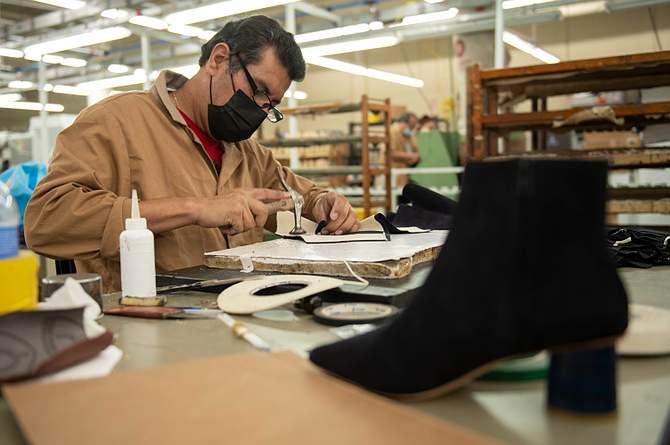 Manuel Muñez works on Ma’am Shoes ankle boots.