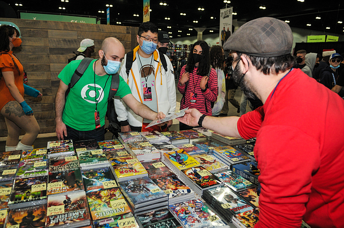 Fans browse comic books.