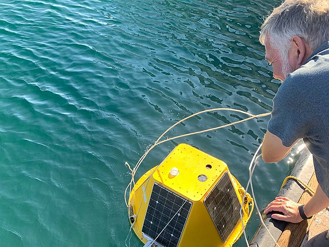 Graeme Rae, CEO of HyperKelp, is in his element while tending to a buoy that carries sensors. The small business is pursuing work with defense giant Northrop Grumman Corp. on projects of common interest. Photo courtesy of HyperKelp.