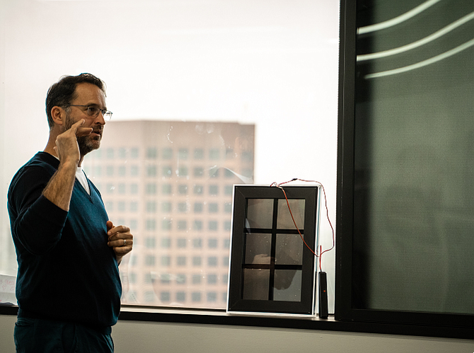 Chief Executive Doug Croxall shows how a small six-pane smart window insert works.