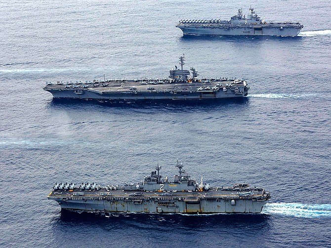 Photo courtesy of U.S. Navy
The USS Essex, in foreground, sails in formation with the USS Abraham Lincoln, center, and USS America on Feb. 7 in the Philippine Sea.