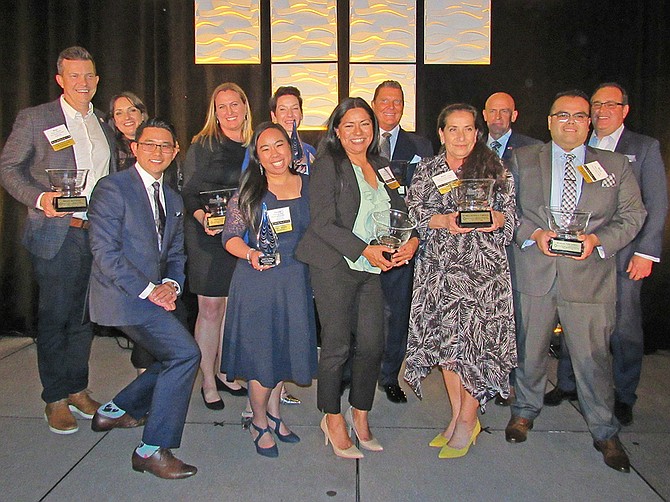 Winners and officials of 42nd annual Gold Key Awards, back row, from left to right: Brian Hilemon, Heather Boye; Ally Marion, Annie Fitzgerald; Edward Kutch; Gary Johnston; Brad Baer. Front row, from left to right: Elvin Lai; Chelsey Ong; Laura Becerra; Maria Zuniga Torres; Marco Vizcarra. Not pictured: winner Magdalena Trevizo. (Photo by Karen Pearlman)