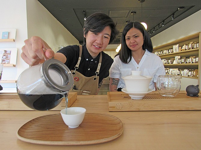 Amy Truong (left) and Lani Gobaleza of PARU Tea brew and share some of their personally mixed batch of Blue Chamomile Tea inside their new La Jolla store on Girard Avenue. Photo by Karen Pearlman