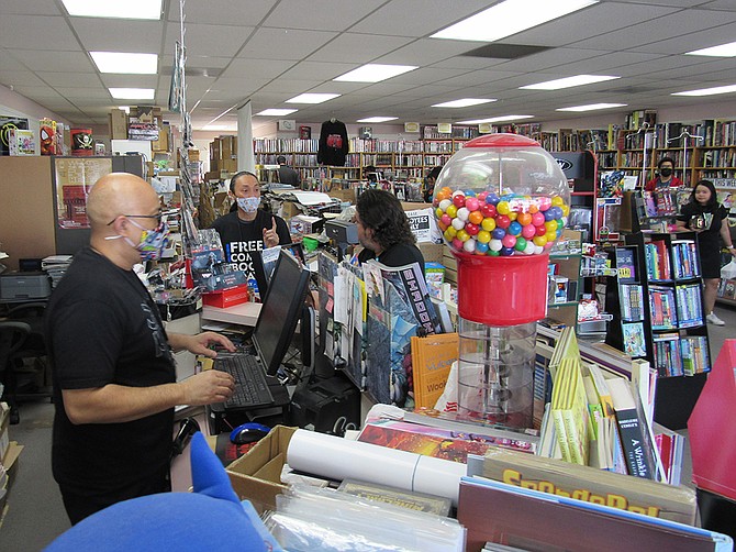 Lucky Bronson (left) and Didi Tan, co-owners of Comickaze, were busy during Free Comic Book Day on Saturday, May 7. Photo by Karen Pearlman