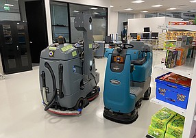 Two Brain Corp autonomous robots stop to avoid each other during a test in the company’s innovation lab. Photo by Jeff Clemetson