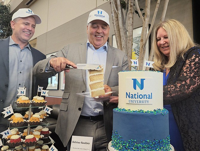 Chris Graham, Dr. Michael Cunningham and Nancy Rohland-Heinrich (left to right) celebrate the merger of National University and Northcentral University at NU’s Kearny Mesa headquarters. Photo by Karen Pearlman